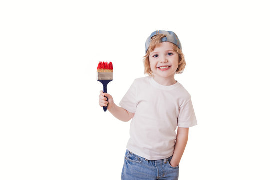 boy in a white T-shirt with a paint brush in his hands, paints on the wall, writes. Red color. isolated white background