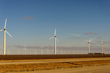 wind turbines in the desert with a blue sky