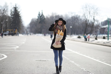 French woman with baguettes in the bag 