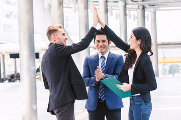 Successful business team giving a high fives gesture at office