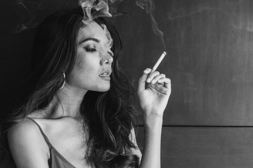 Obraz premium Fashion portrait of beautiful woman sexy slim body smoking cigarette
