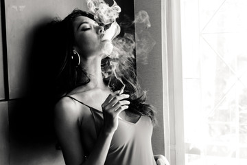 Fashion portrait of  beautiful woman sexy slim body smoking cigarette