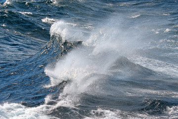 Blue ocean wave on Windy Rough sea day. Cruise ship Vacation. Big surf.