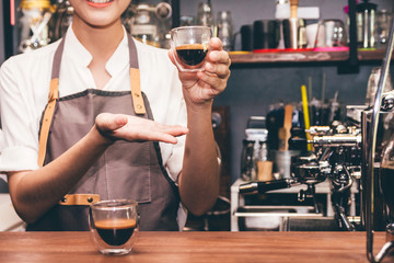 Barista holding coffee in coffee shop
