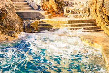 waves of the Adriatic sea hitting Dubrovnik 

