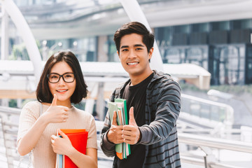 Group of students holding notebooks outdoors.Education concept