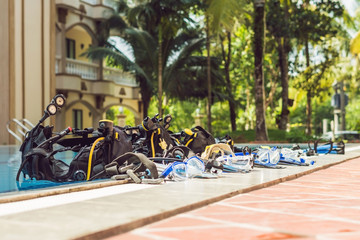 Equipment for diving is on the edge of the pool, ready for a lesson