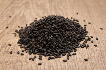 Benniseed. Pile of grains on the wooden table. Selective focus.