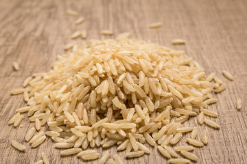 Whole Chinese Rice seed. Pile of grains on the wooden table. Selective focus.