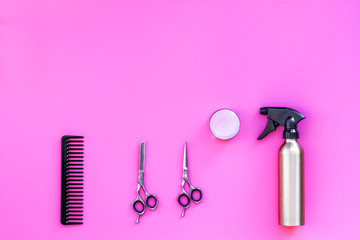 Professional tools for haircut. Sciccors, comb, spray on pink background top view copy space