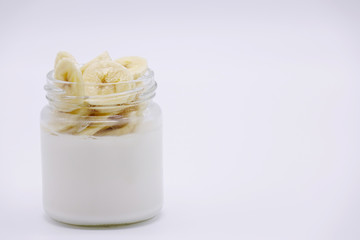 Fresh berries in the jar with the yogurt. On white background.