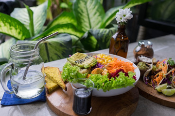 Healthy food breakfast. Fresh green salad witha carrot, avocado, and other vegetables, top view