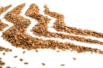 Creative layout made of organic flax seeds isolated on white background. Flat lay. Food concept.