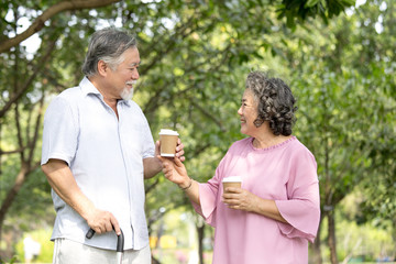 Obraz premium Asian Senior couple smiling together at outdoor park. People lifestyle concept.
