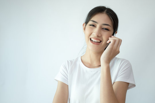 Portrait of Attractive Asian Woman using smartphone with smiling on white background.