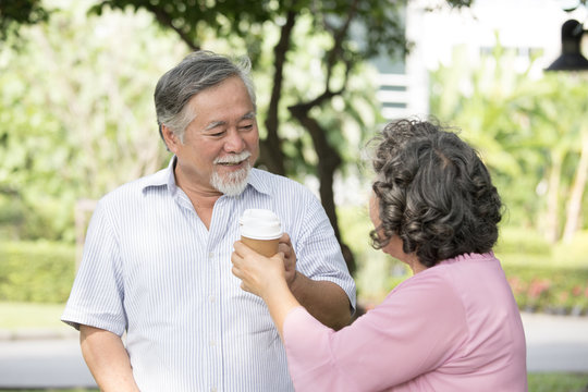 Asian Senior couple smiling together at outdoor park. People lifestyle concept.