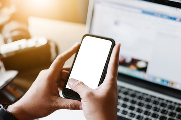 Close up of man using mobile smart phone,sending massages on the garden.having sunbath.Phone with black screen,texting,video calls,