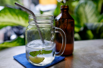 Fresh coconut juice with lime and ice on table in cafe. Concept of healthy drink in summer