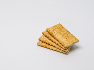 Healthy crackers in a stack on a white background.