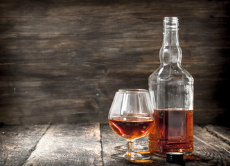 French cognac in a bottle with glasses.
