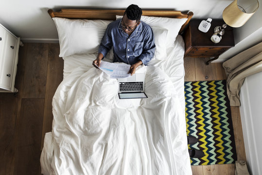 Business Man In Bed Working