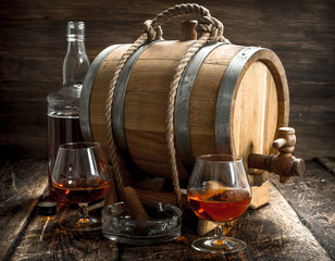 Barrel with French cognac, glasses and a cigar.