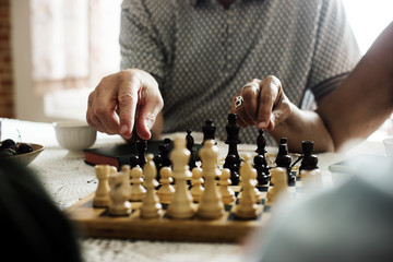 Senior friends playing chess together