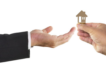 Fototapeta na wymiar Man hand holding wooden toy house with businessman hand receiving isolated on white background with clipping path