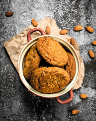 Oatmeal cookies in a bowl with nuts.