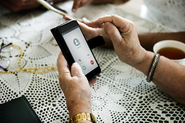 Closeup of hands using mobile phone