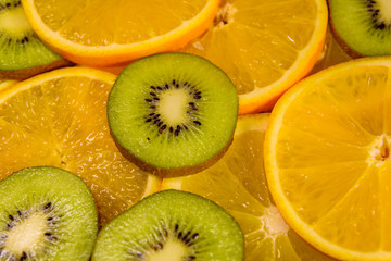 Fototapeta na wymiar Background of the kiwi and orange fruits