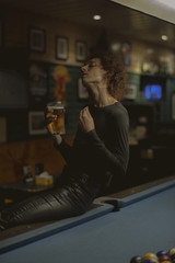 Plakat Woman having a beer at a bar