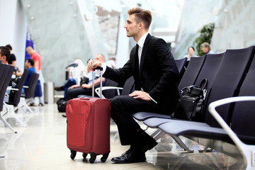 A businessman sitting in the airport.