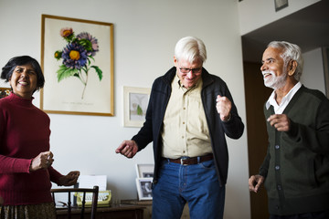 Fototapeta premium Senior people dancing together in a living room