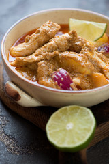 Massaman curry with chicken served in a bowl, close-up, selective focus, vertical shot