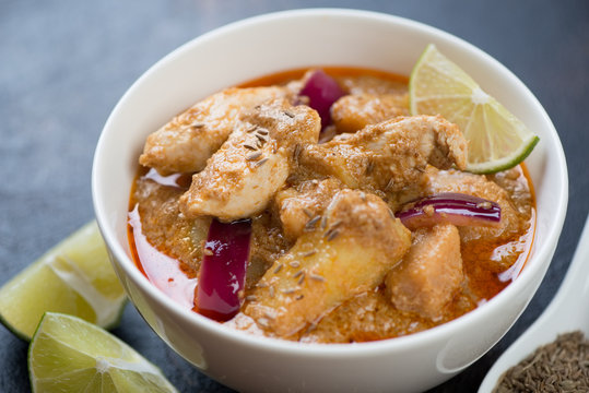 Close-up of thai massaman curry with chicken meat and potato served in a white bowl, selective focus