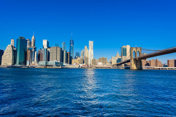 Fototapeta premium Brooklyn Bridge and the Lower Manhattan skyline panorama from Brooklyn Bridge Park riverbank, New York City, USA