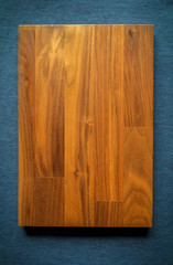 Empty Top view square wood plate on blue fabric background . free space for product and for your