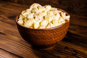 Salad with the haricot beans and meat dressed with mayonnaise in ceramic bowl