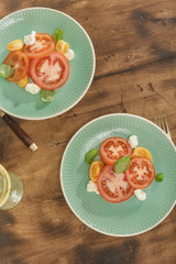 Italian salad with tomatoes and mozzarella cheese with white wine