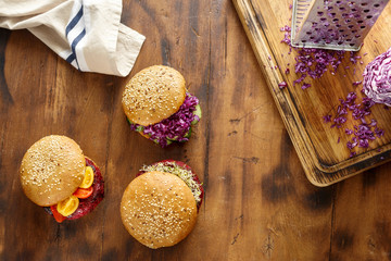 Set of different vegetarian burgers on wooden table