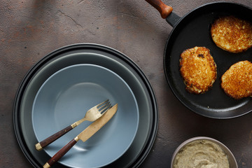 Close up potato pancakes and mushroom sauce dark background