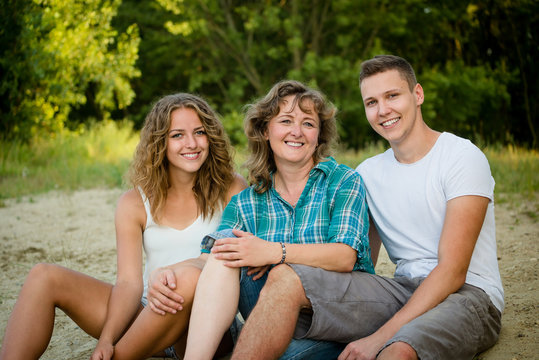 Happy mother, son and daughter outdoors. Affectionate family.
