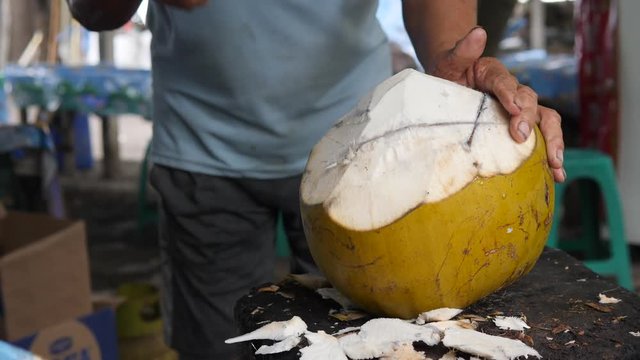 Street Vendor Fruits Seller Cutting and Chopping Young Coconut with Machete Knife. 4K.