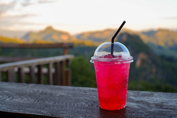 Red Water in glass and natural mountain in Chiang Mai, Thailand.