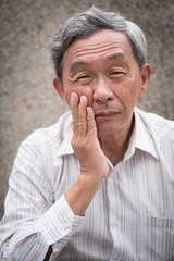 sick old senior man with toothache, dental care concept