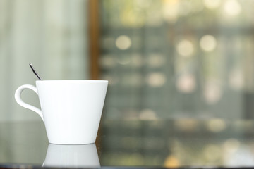 Hand holding of A cup of coffee with outdoor background