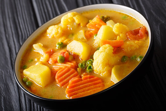 Vegetarian curry from vegetables with coconut milk close-up in a bowl. horizontal