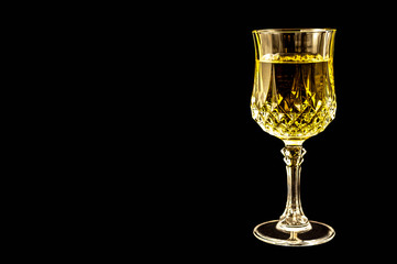 White Wine in a Crystal Goblet ready for relaxation and enjoyment. Chablis, Chardonnay, or Reisling, this glass of wine is ready for tasting. Room for text.