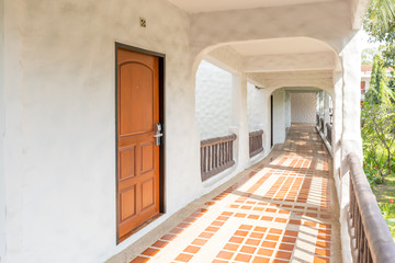 Perspective of the long corridor in hotel with sunlight and nature view
